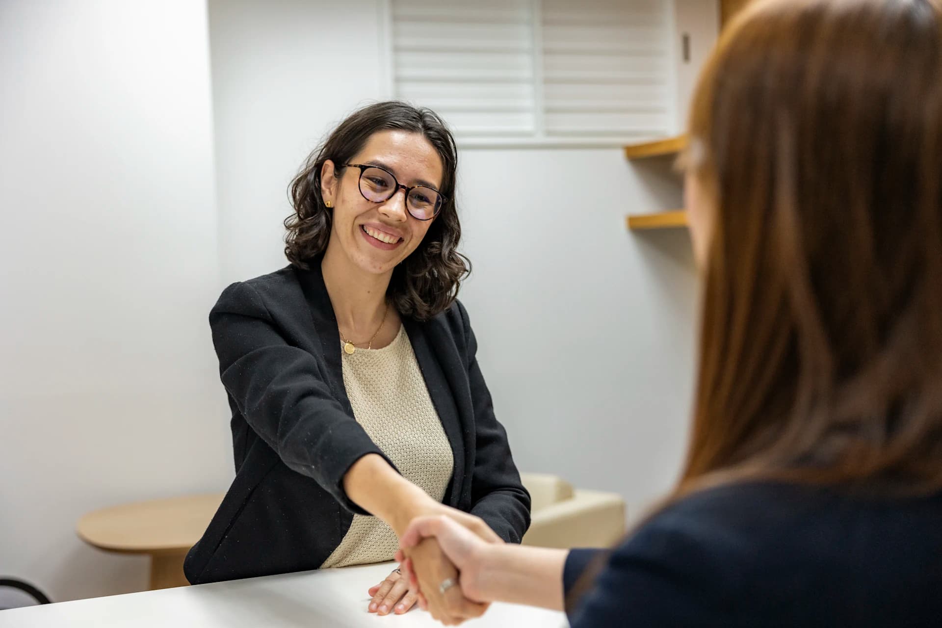 Profissional de RH cumprimentando candidata em entrevista